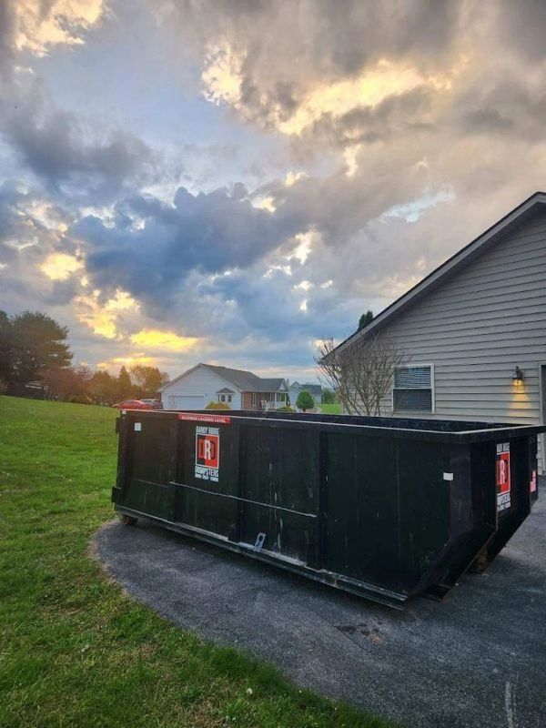 A 15-yard Dandy Ridge Dumpsters roll-off in a driveway during a garage cleanout in Jefferson County, TN