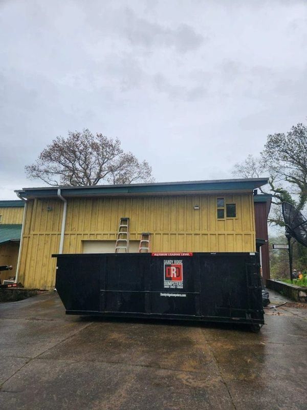 A Dandy Ridge Dumpsters roll-off dumpster in a driveway during a home project in Jefferson County, TN