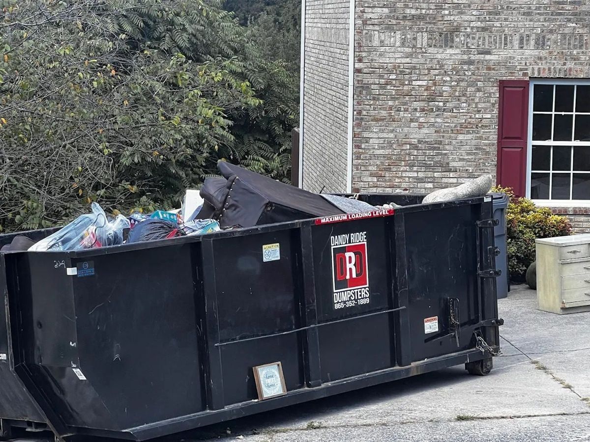 A Dandy Ridge Dumpsters roll-off loaded with roofing shingles from a tear-off in Jefferson County, TN
